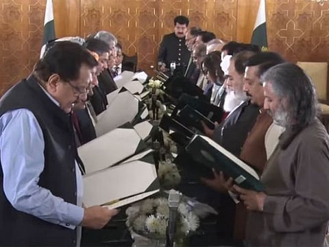 Senate Chairman Sadiq Sanjrani administers oath to the new federal cabinet. 