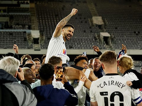Fulham's Aleksandar Mitrovic celebrates with teammates after being promoted to the Premier League.