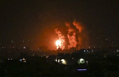 Flames and smoke rise during Israeli air strikes central Gaza strip in on April 21, 2022. 