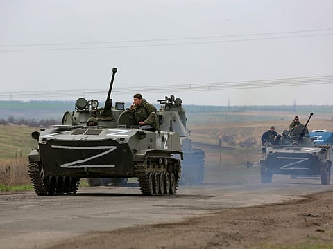Russian military vehicles move on a highway in an area controlled by Russian-backed separatist forces near Mariupol, Ukraine, Monday, April 18, 2022.