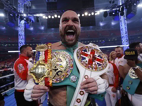 Tyson Fury celebrates with the belts after winning his fight against Dillian Whyte at Wembley Stadium.