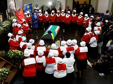 Woman in church uniforms gather around the coffin of police diver Sergeant Busisiwe Mjwara who died while searching for flood victims, at her official funeral in Pietermaritzburg, South Africa, April 22, 2022.