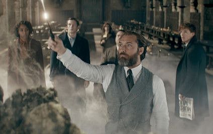 Jude Law, center foreground, with, from left, Jessica Williams, Callum Turner, Fiona Glascott, Dan Fogler and Eddie Redmayne in “Fantastic Beasts: The Secrets of Dumbledore.” 