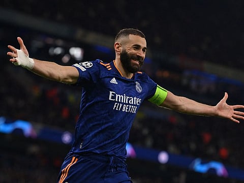 Real Madrid's French striker Karim Benzema celebrates after scoring his team's third goal through a penalty kick  in the Uefa Champions League semi-final first leg against Manchester City at the Etihad Stadium on Tuesday.