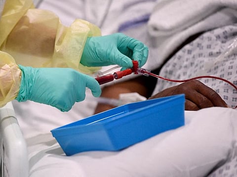A nurse helps a COVID-19 patient in the ICU (Intensive Care Unit) at Milton Keynes University Hospital in Britain in a file photo.