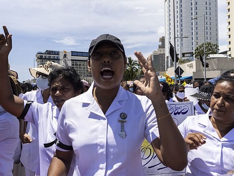 Healthcare workers shout in a march during the national strike and protest in Colombo, Sri Lanka, on  April 28, 2022.  