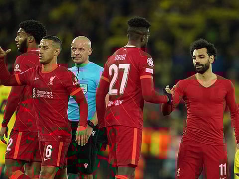Liverpool weathered an early Ajax storm before Mohamed Salah gave them a half-time lead.