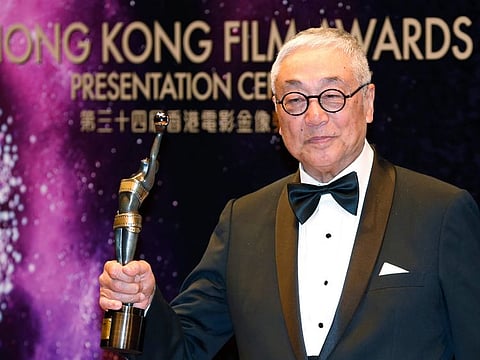 Hong Kong actor Kenneth Tsang poses after winning the Best Supporting Actor award for his movie “Overhead 3” during the Hong Kong Film Awards in Hong Kong Sunday, April 19, 2015.