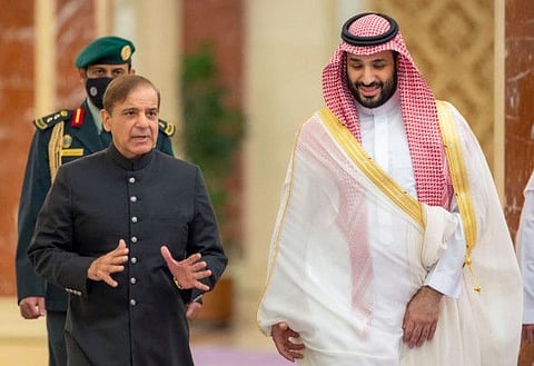 A handout picture provided by the Saudi Royal Palace shows Saudi Arabia's Crown Prince Mohammed Bin Salman welcoming Pakistani Prime Minister Shehbaz Sharif in Jeddah on April 30, 2022. 