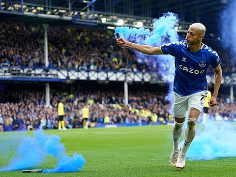 Everton's Richarlison runs with a flare as he celebrates after scoring his sides first goal during the Premier League match against Chelsea at Goodison Park in Liverpool on Sunday.=