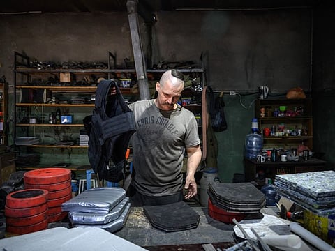 Andrii Paliy prepares a ballistic jacket using armour plating that he makes at his workshop in Zaporizhzhia on May 1, 2022.