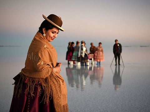 Bolivian boy turns photographer on iconic salt flats - with help from a dinosaur