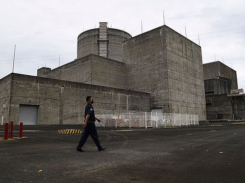 A security guard walking in front of the main gate of the Bataan Nuclear Power Plant in the town of Morong in Bataan 