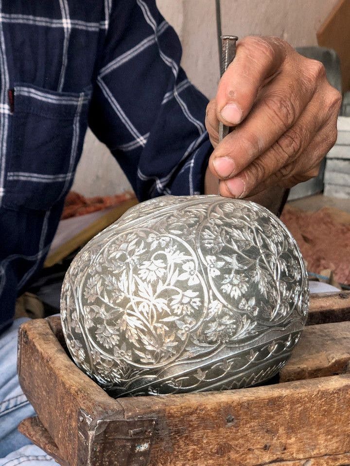 An artisan at work moulding Bidriware item-1651830257764