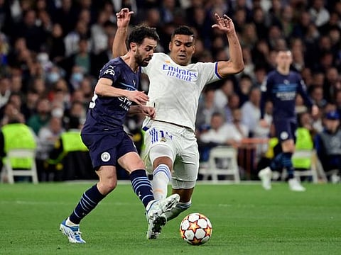 Manchester City's Portuguese midfielder Bernardo Silva (left) vies with Real Madrid's Brazilian midfielder Casemiro during the UEFA Champions League semi-final second leg at the Santiago Bernabeu stadium in Madrid.