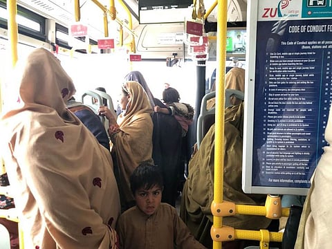 Women travel with children on the new public bus system in Peshawar on March 9, 2022.  