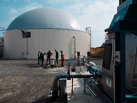 French farmers stand as they talk in a gas plant outside the village of Sonchamp, south of Paris, Tuesday, May 3, 2022.