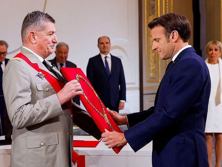 Macron is presented the great necklace of France's National Order of the Legion of Honour by its great chancellor General Benoit Puga, and recognized as the order's grand master at the Elysee presidential palace in Paris on May 7, 2022, during the investiture ceremony as French President, following his re-election last April 24.