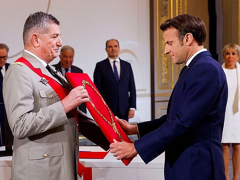 Macron is presented the great necklace of France's National Order of the Legion of Honour by its great chancellor General Benoit Puga, and recognized as the order's grand master at the Elysee presidential palace in Paris on May 7, 2022, during the investiture ceremony as French President, following his re-election last April 24.  