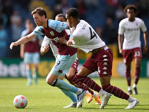 Burnley's Dutch striker Wout Weghorst (left) vies with Aston Villa's English defender Ezri Konsa (centre) during the English Premier League football match at Turf Moor in Burnley, north west England.