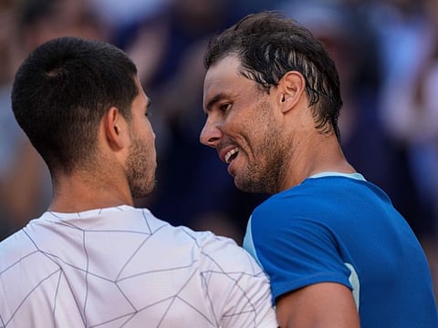 Rafael Nadal (right) congratulates Carlos Alcaraz after their match at the Mutua Madrid Open tennis tournament in Madrid.