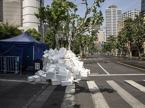 Styrofoam boxes are piled on the side of a street during a lockdown in Shanghai on  May 7, 2022. 