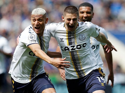 Everton's Vitaliy Mykolenko celebrates scoring their first goal with Richarlison.