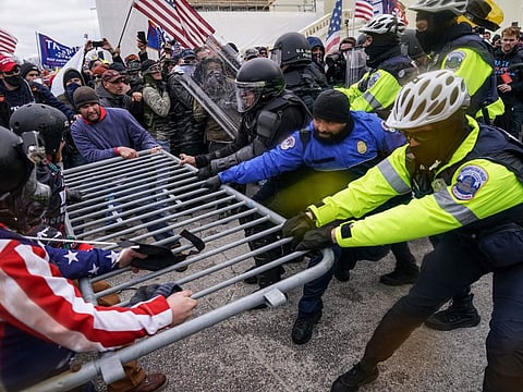 Rioters try to break through a police barrier at the Capitol in Washington on January 6, 2021. News organisations are using sophisticated new technologies to transform the way they conduct investigations. Much of it is publicly available, or “open-source” material from mobile phones, satellite images and security cameras, but it also extends to computer modelling and artificial intelligence. A reporting form that barely existed a decade ago is becoming an important part of journalism's future. (AP Photo/John Minchillo, File)