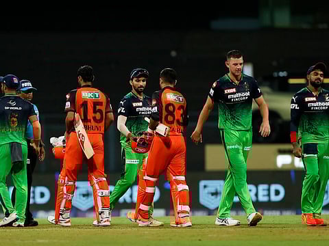Players of Royal Challengers Bangalore and Sunrisers Hyderabad shake hands at the end of match 54 of the TATA Indian Premier League 2022 (IPL season 15) at the Wankhede Stadium in Mumbai.