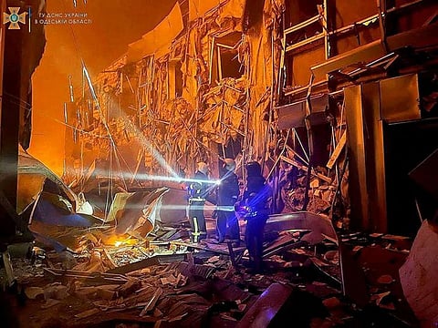 First responders work at the site of a missile strike in Odesa, on May 10, 2022.   