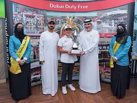Winner Sara Ali (centre), is flanked by Salah Tahlak (right), EGF Director General Akram Skaik and Dubai Duty Free crew members.