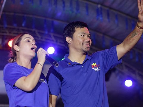Philippine boxing icon and presidential candidate Manny Pacquiao  waving to supporters next to his wife Jinkee during a campaign rally in General Santos City, on the southern island of Mindanao in a file photo.
