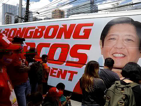 Supporters of presidential candidate Ferdinand "Bongbong" Marcos Jr. gather to celebrate as partial results of the 2022 national elections show him with a wide lead over rivals, outside the candidate's headquarters in Mandaluyong City, Philippines, May 10, 2022.