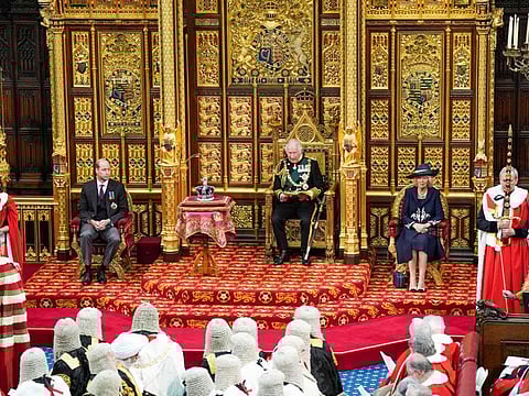 Britain's Prince Charles, Prince of Wales  (second right) reads the Queen's Speech as he sits by the Imperial State Crown (2nd left), Britain's Camilla, Duchess of Cornwall and Britain's Prince William, Duke of Cambridge in the House of Lords chamber, during the State Opening of Parliament, at the Houses of Parliament, in London, on May 10, 2022. 