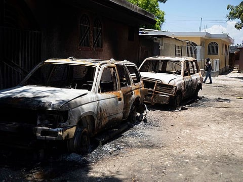 Burnt out vehicles sit on the side of a road in La Plaine neighbourhood of Port-au-Prince, Haiti, Friday, May 6, 2022.