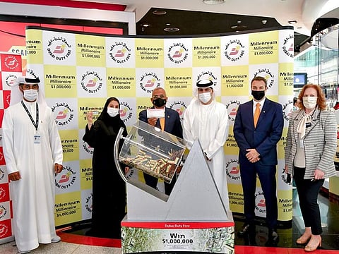Dubai Duty Free officials pick the winning ticket for the Millennium Millionaire Series 388 at Dubai International Airport