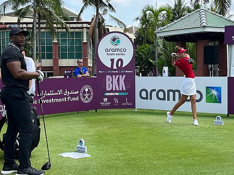 Dubai-based Chiara Noja teeing off on Hole 10 at Thai Country Club as Victor Green (left), a NFL legend and her amateur playing partner, looks on.