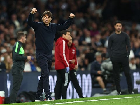 Tottenham Hotspur manager Antonio Conte celebrates after the match as Arsenal manager Mikel Arteta looks on.
