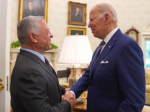 This handout picture released by the Jordanian Royal Palace shows US President Joe Biden receiving Jordan's King Abdullah II at the White House in Washington, DC, on May 13, 2022. 