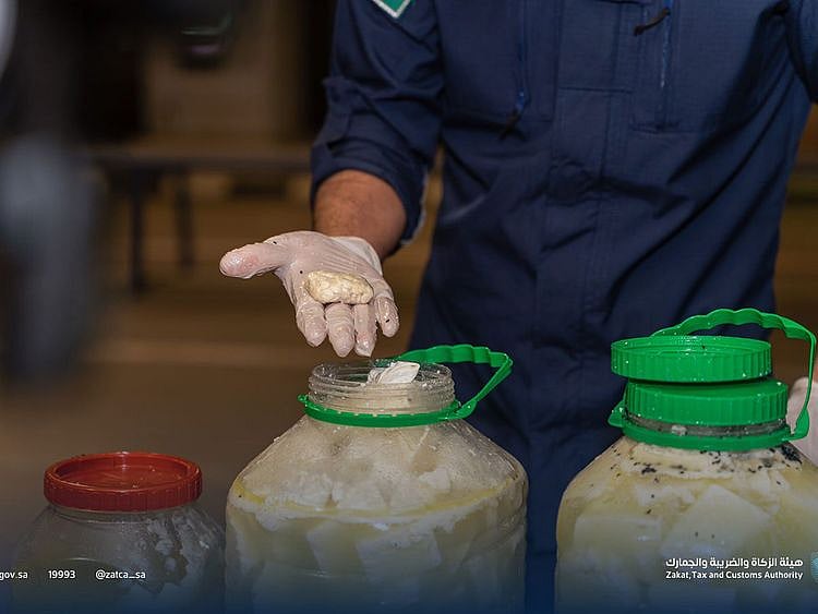 An official shows Captagon drug pills stashed into a cheese.