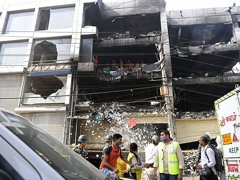 NDRF personnel carry out search and rescue operations at the four-storey building where a fire broke out that left at least 27 persons dead and 12 injured near Mundka Metro station, in Delhi, on Saturday.  Three more people died on Saturday.