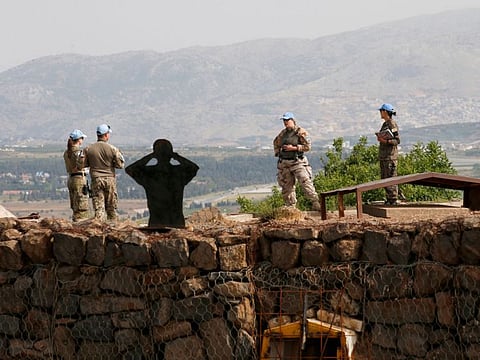 A picture taken in the Golan Heights on May 14, 2022, shows members of the United Nations Disengagement Observer Force (UNDOF) monitoring the Syrian side of the border with Israel, following an Israeli air strike on central Syria. 