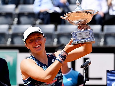 Poland's Iga Swiatek poses with the winner's trophy after defeating Tunisia's Ons Jabeur to win the final of the Women's WTA Rome Open tennis tournament at Foro Italico in Rome.