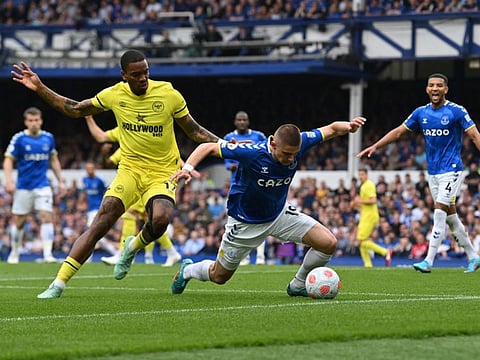 Everton's Ukrainian defender Vitaliy Mykolenko (right) fights for the ball with Brentford's English striker Ivan Toney during the English Premier League match at Goodison Park in Liverpool, north west England.