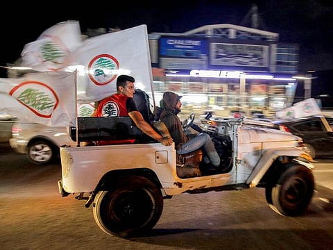Supporters of the Lebanese Forces party celebrate in the Lebanon's northern coastal city of Batroun as they await results after the end of voting in the parliamentary elections on May 15, 2022. 