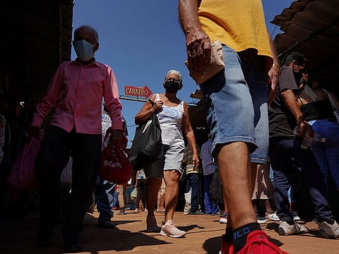People walk in a public market in Havana, Cuba May 13, 2022.