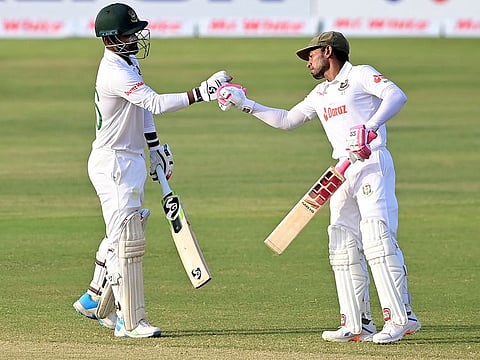 Bangladesh's Liton Das (left) with teammate Mushfiqur Rahim after scoring a half-century during the third day of the first Test against Sri Lanka at the Zahur Ahmed Chowdhury Stadium in Chittagong on Tuesday.