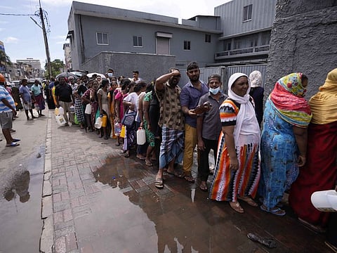 People queue up to buy kerosene oil for cooking amid shortages in Colombo, on May 17, 2022. 