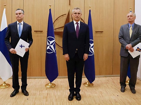 Finland's Ambassador to Nato Klaus Korhonen, left, Nato Secretary-General Jens Stoltenberg and Sweden's Ambassador to Nato Axel Wernhoff attend a ceremony to mark Sweden's and Finland's application for membership in Brussels, Belgium, on  May 18, 2022. 