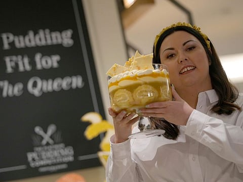 Jemma Melvin, the Platinum Jubilee Pudding winner, poses for the media with her creation, at a department store in London.
